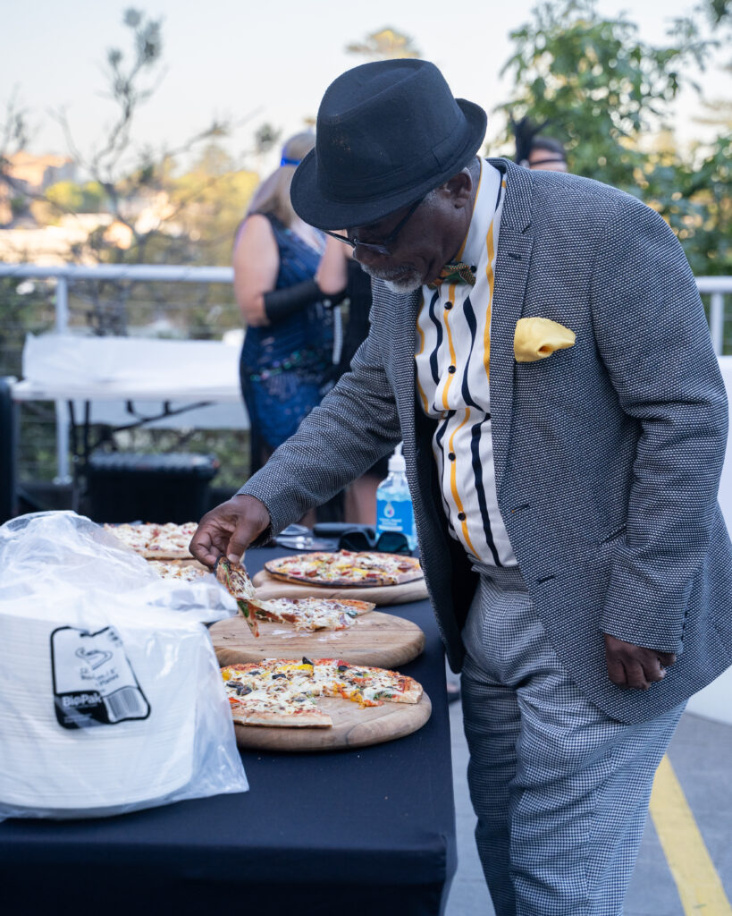 Customer taking a fresh slice of Pizza